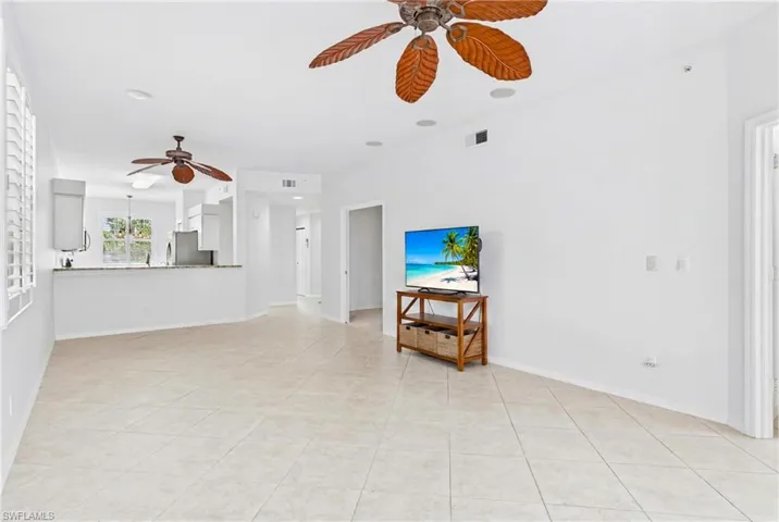 The spacious living room is the heart of the home, offering an open and inviting setting that's perfect for entertaining guests or enjoying a relaxing evening after a day on the golf course.