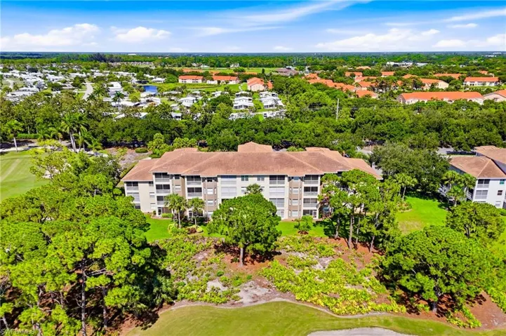 Breathtaking aerial view showcasing the beautifully designed Highland Woods Golf & Country Club, surrounded by lush tropical landscaping and pristine fairways.