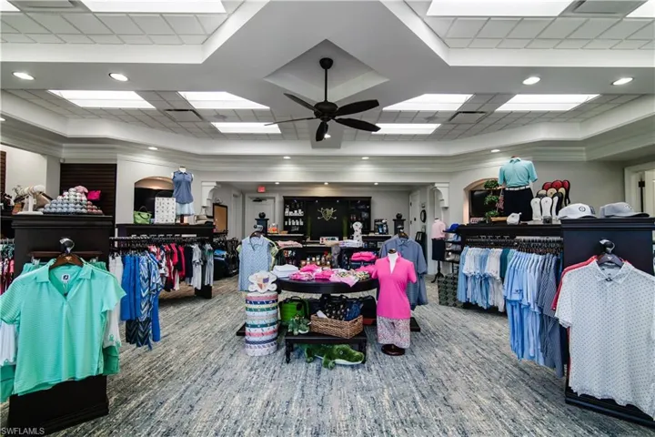 Misc room with ceiling fan, a tray ceiling, ornamental molding, and carpet flooring