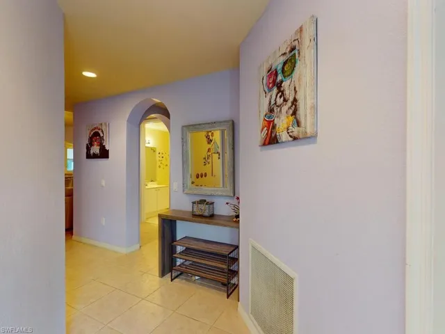 Hallway featuring light tile flooring