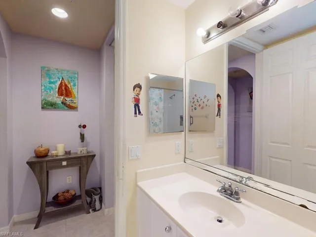 Bathroom with tile floors and vanity with extensive cabinet space