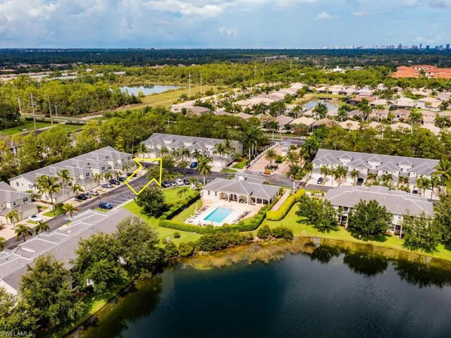 Birds eye view of property with a water view