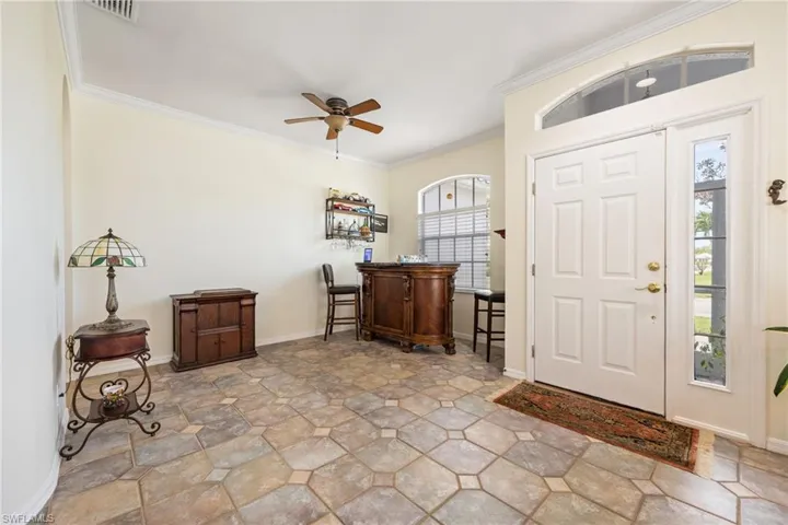 Neutral decorative tile entry with dining area and sitting area...great for entertaining! Cocktail anyone?!