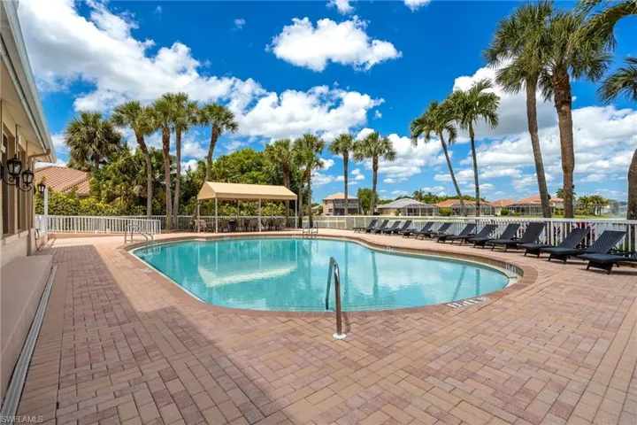 Silverlakes Community Pool with brick pavers and plenty of lounges and a canopy to relax in shade.