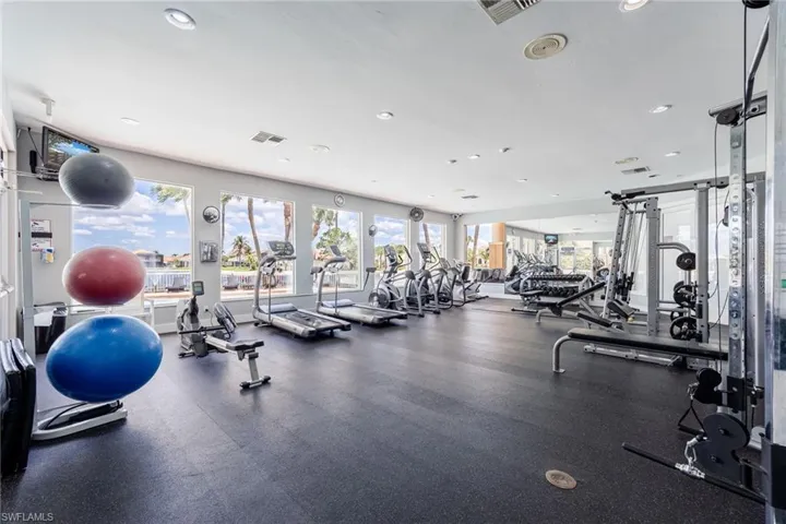 Nice size fitness room with various equipment. Overlooking the community pool.