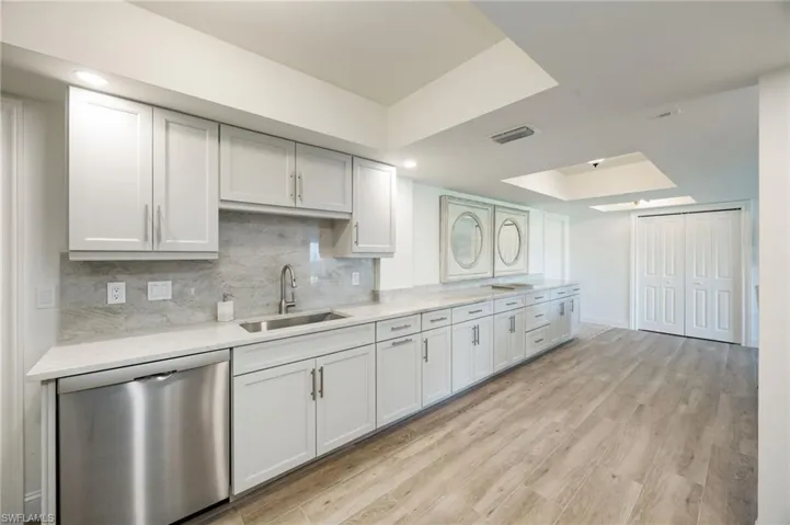 Kitchen offers massive storage and serving bar.