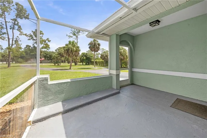 Screened porch with textured plaster walls and a painted concrete floor