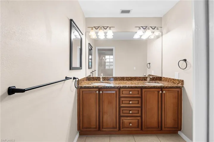 Dual vanity with granite-style countertop and integrated sinks