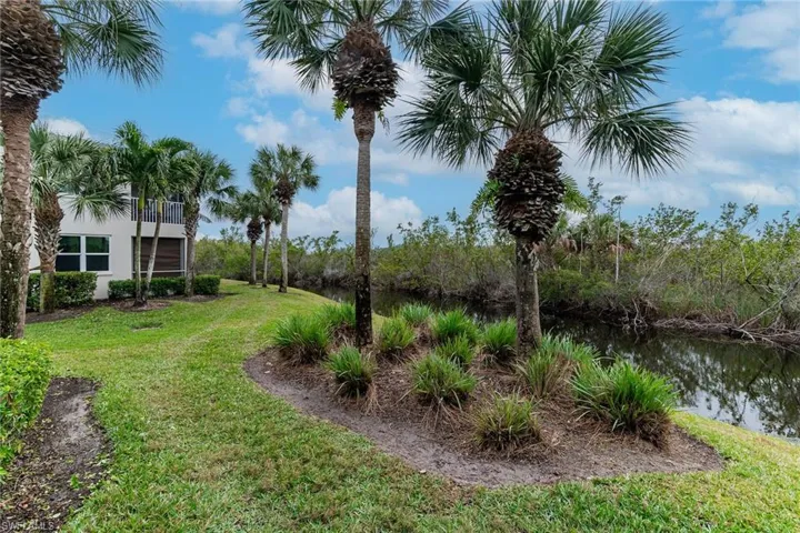View of green lawn featuring a water view