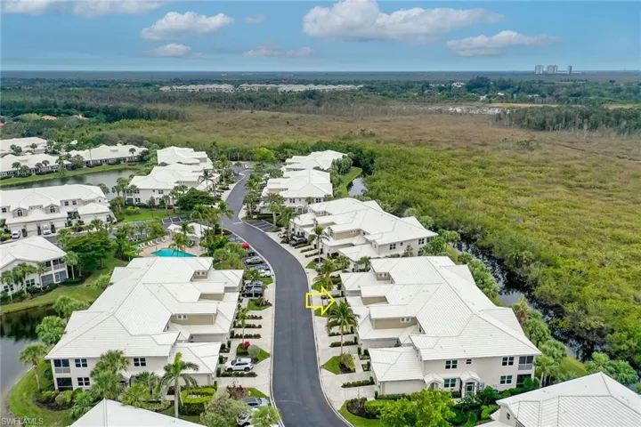 Aerial perspective of suburban area featuring a large body of water