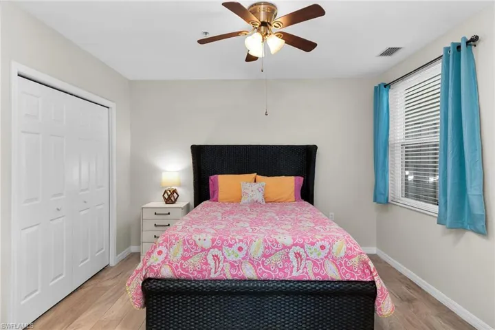 Bedroom featuring light wood-style flooring, ceiling fan, and a closet