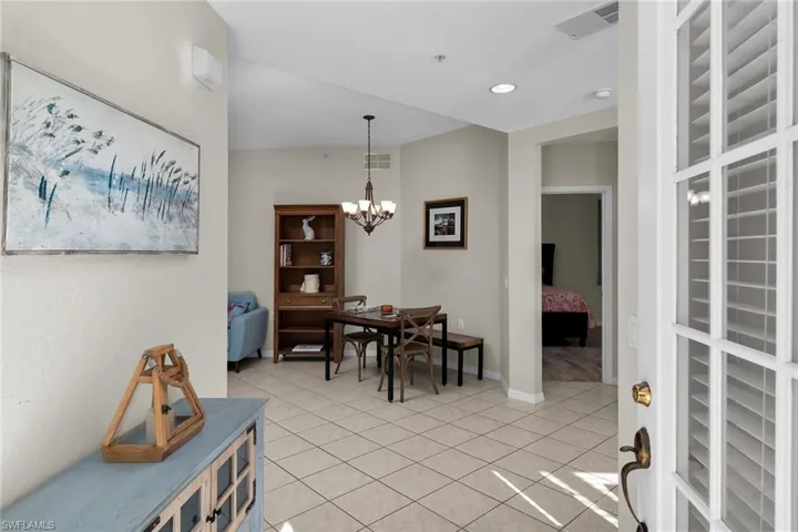Dining area featuring a chandelier and light tile patterned flooring