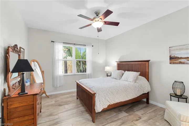 Bedroom with light wood finished floors and a ceiling fan