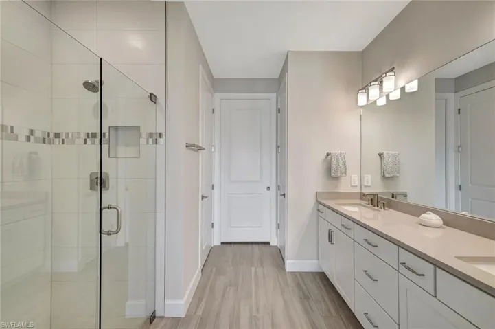 Ensuite Primary Bathroom with double vanity, spacious stall shower & separate water closet