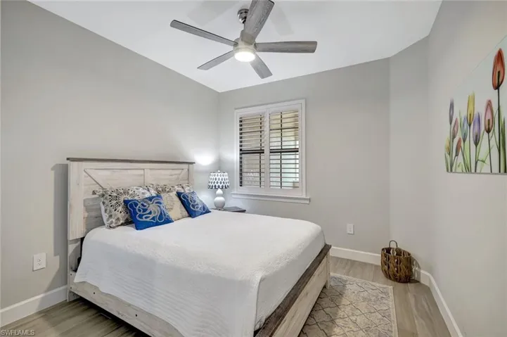 Second Bedroom featuring tile floors, plantation shutters and ceiling fan