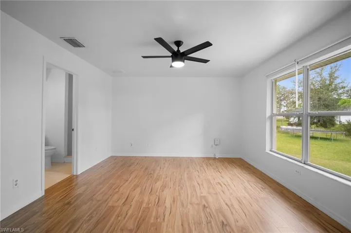 Empty room with light wood-style flooring and a ceiling fan