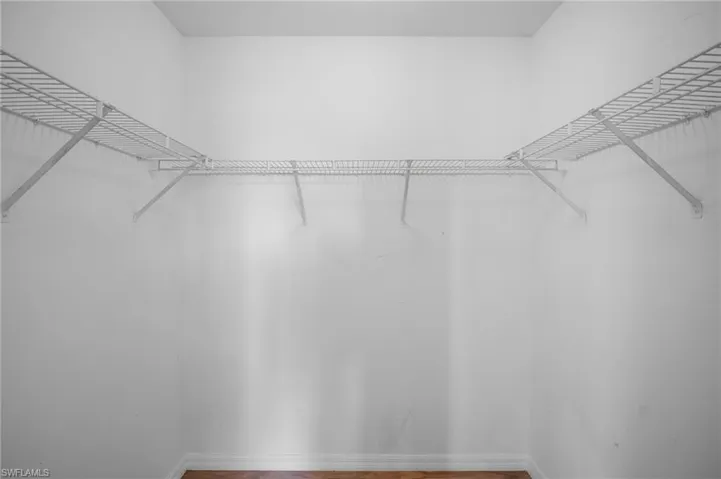 Walk in closet featuring wood finished floors