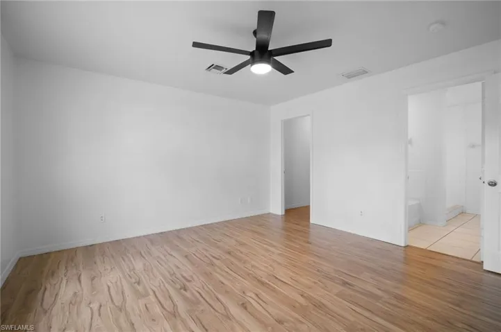 Empty room with light wood-style flooring and ceiling fan