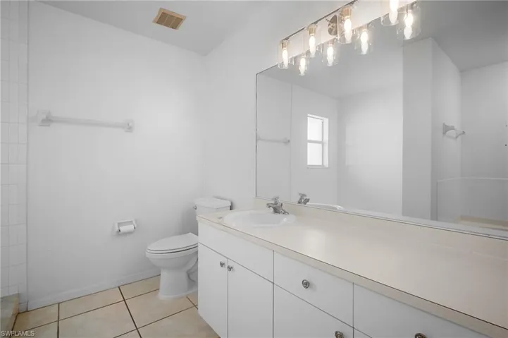 Bathroom with vanity and light tile patterned flooring
