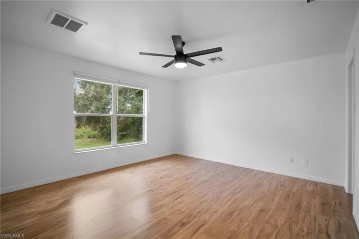 Spare room featuring light wood-style floors and ceiling fan