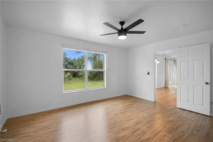 Unfurnished room featuring light wood-style floors and a ceiling fan