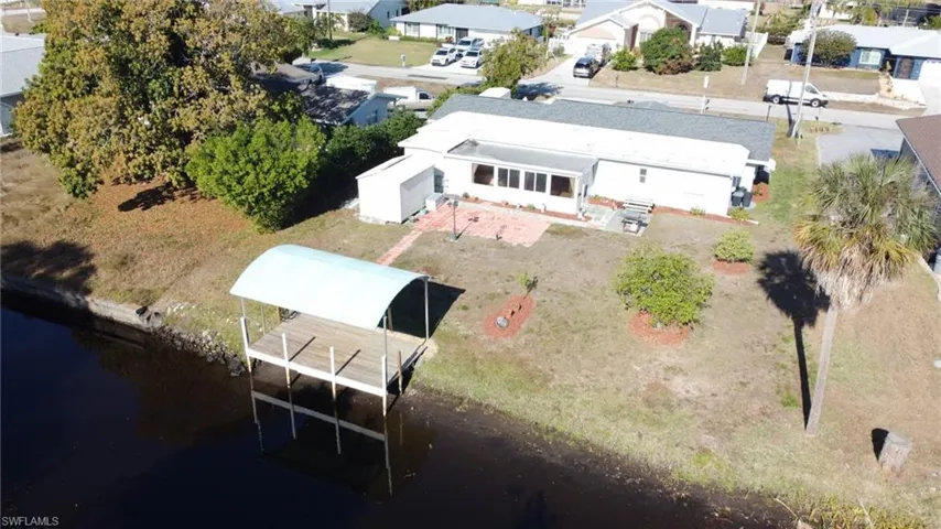 Aerial view of residential area featuring a large body of water