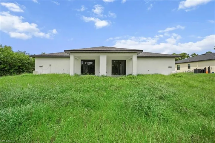 Rear view of property with stucco siding