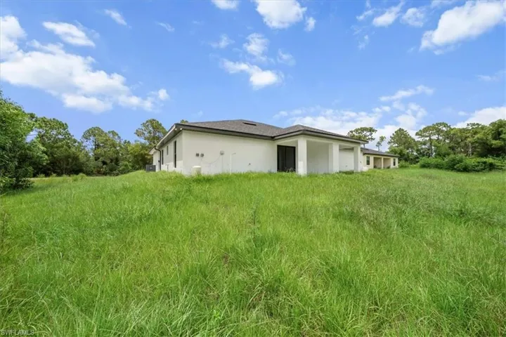 View of side of home with stucco siding