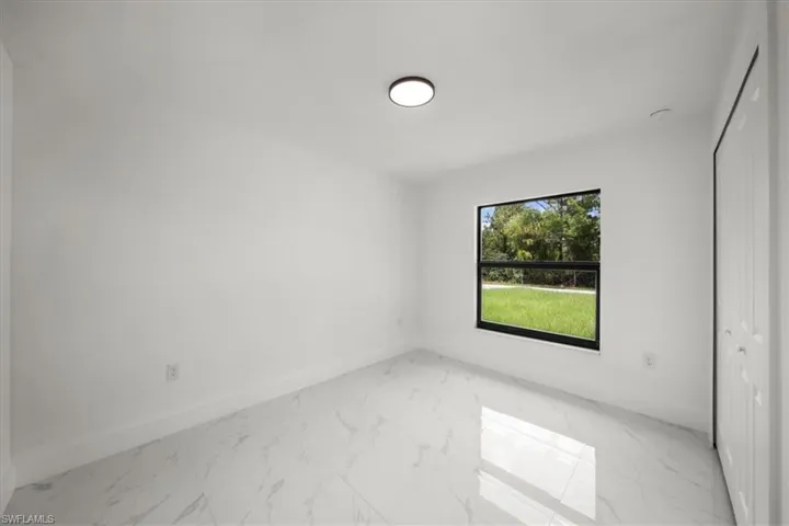 Spare room featuring light marble finish flooring
