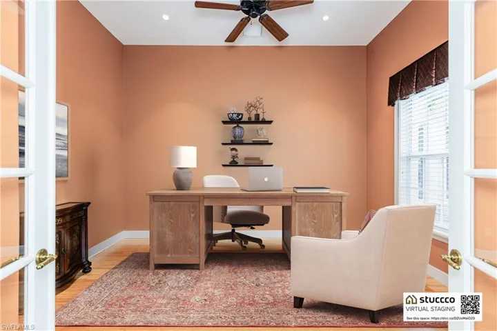 Office area with wood-type flooring and ceiling fan
