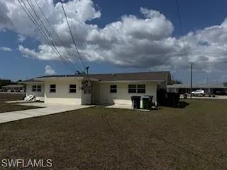 Back of property featuring a lawn and a patio area
