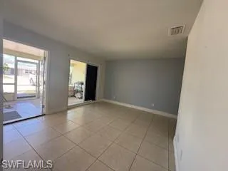 1 BR Family room with light tile patterned floors and baseboards