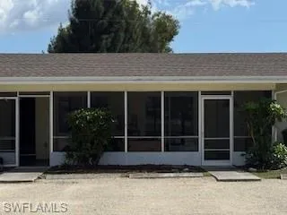 Front of property featuring roof with shingles and a sunroom