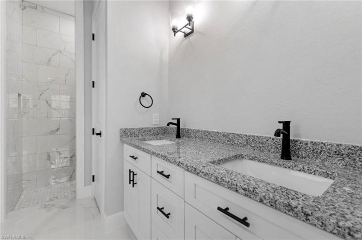 Dual sinks, stand up shower and tub