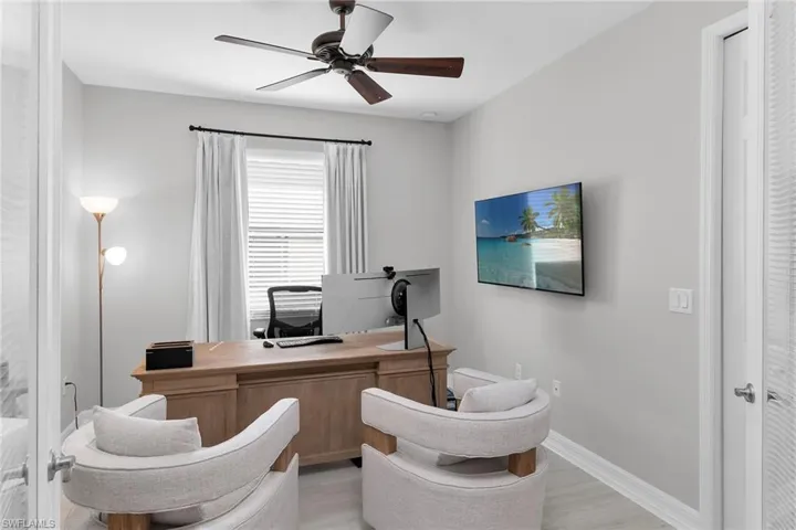 Home office with ceiling fan and light wood finished floors