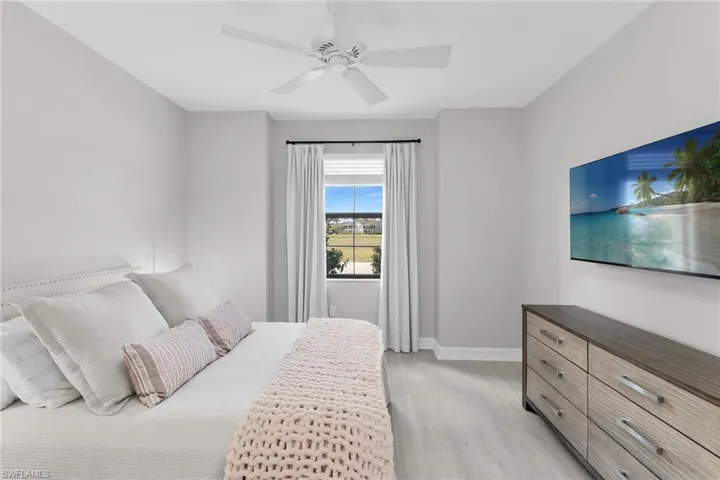 Bedroom with light wood-type flooring and a ceiling fan