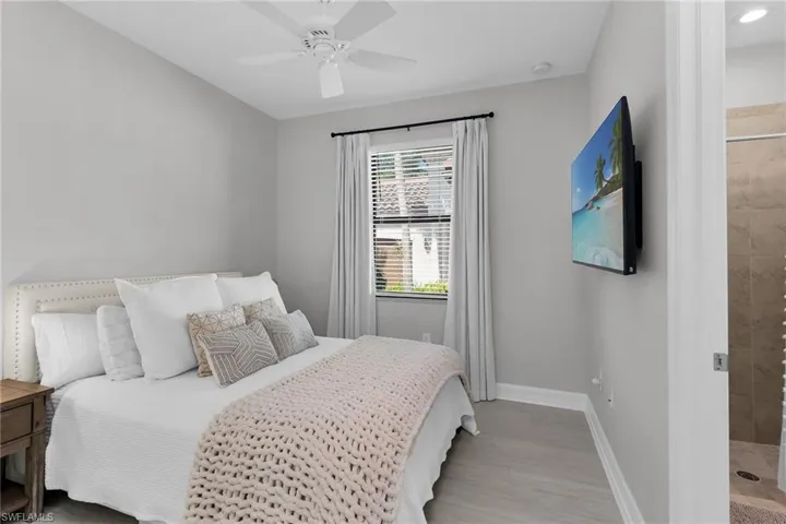 Bedroom with a ceiling fan and light wood finished floors