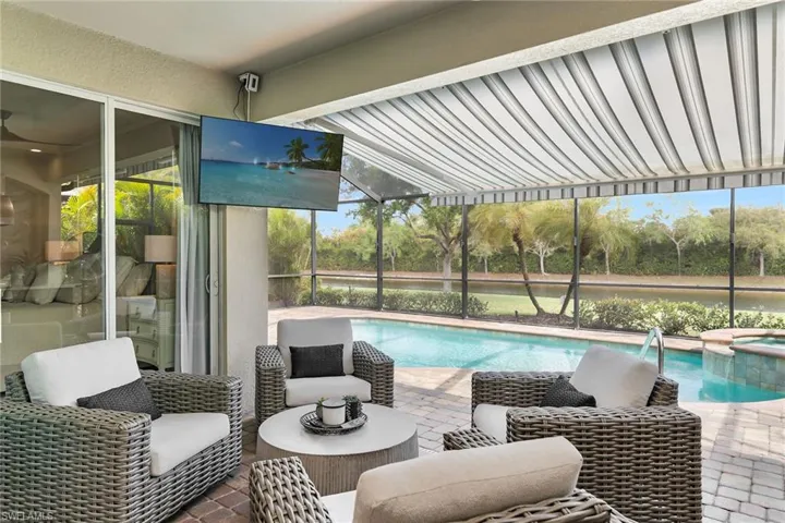 Integrated pool / hot tub with a patio and glass enclosure