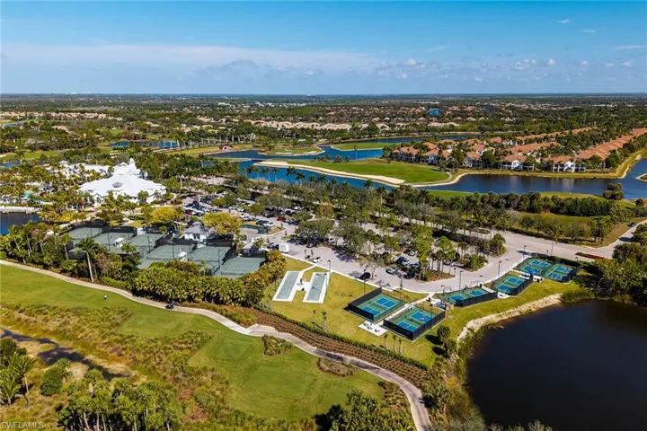 Aerial perspective of suburban area with a nearby body of water and a local golf course