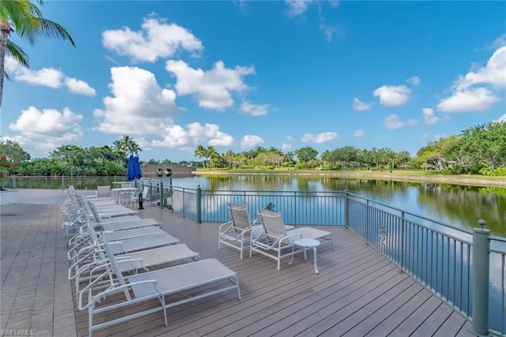Dock area featuring a water view and view of scattered trees
