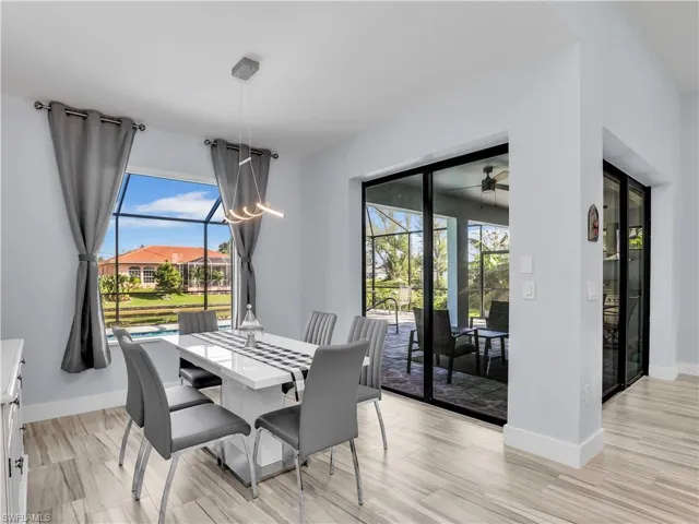 Dining space featuring ceiling fan, light wood-type flooring, and a healthy amount of sunlight