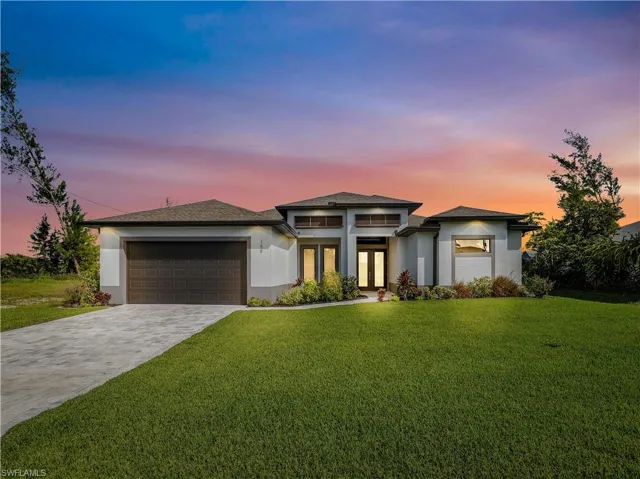 Prairie-style house with a yard and a garage