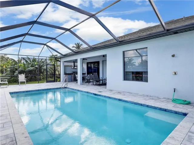 View of swimming pool with a patio and a lanai