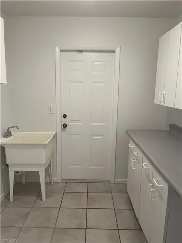 Laundry room with light tile floors