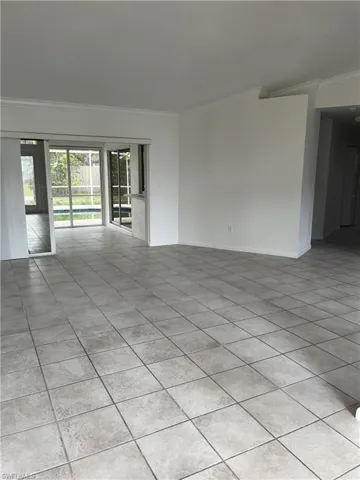 Spare room with light tile flooring and crown molding