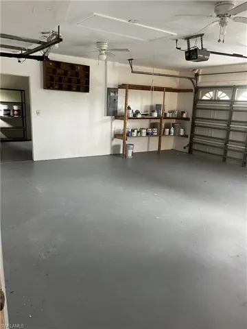 Garage featuring ceiling fan and a garage door opener