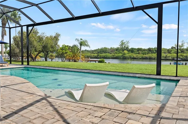 View of pool with a patio, a lanai, and a amazing river views