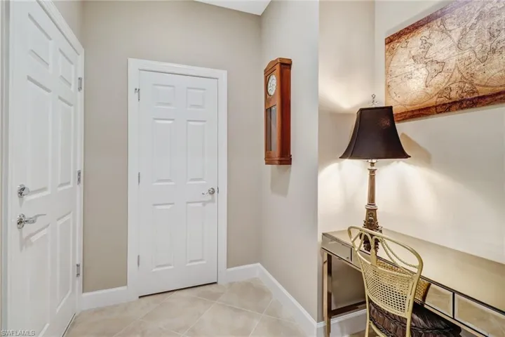 Foyer entrance featuring light tile patterned floors and baseboards