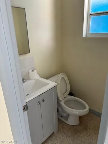 Half bath with vanity and toilet