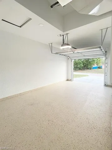 Garage featuring a garage door opener